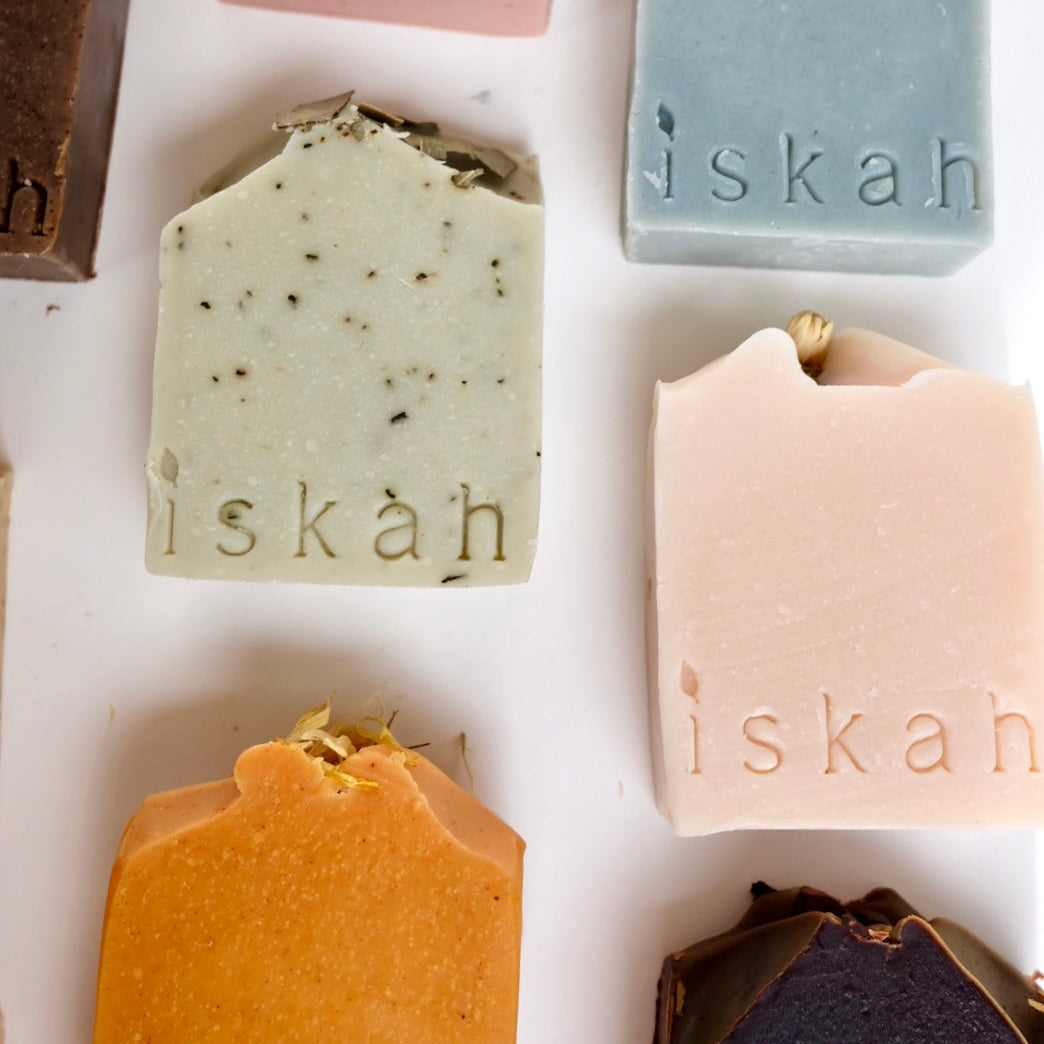 Assorted bars of tallow soap with 'iskah' branding on a white background