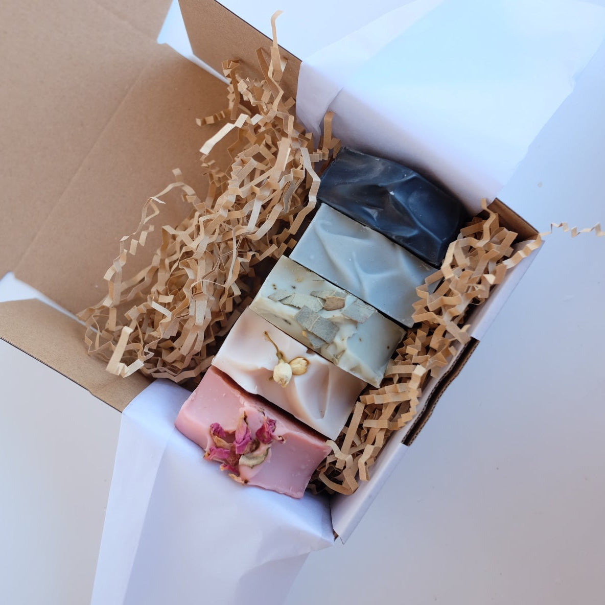 Box of assorted tallow soaps with a white background