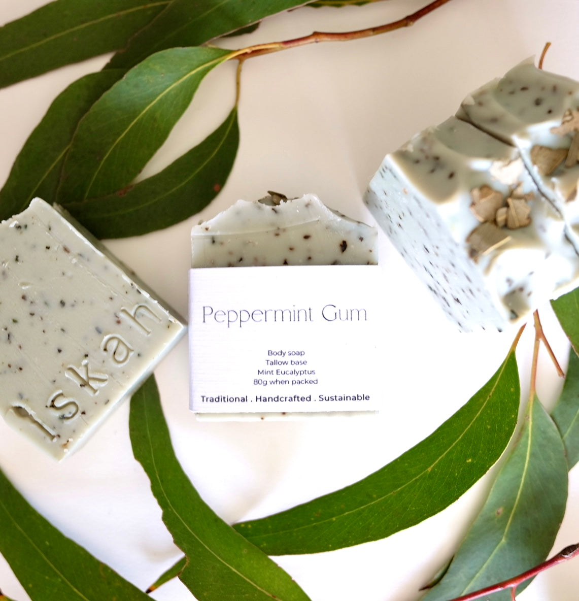 handmade tallow soaps made with french green clay and peppermint eucalyptus oil sitting surrounded by gum leaves